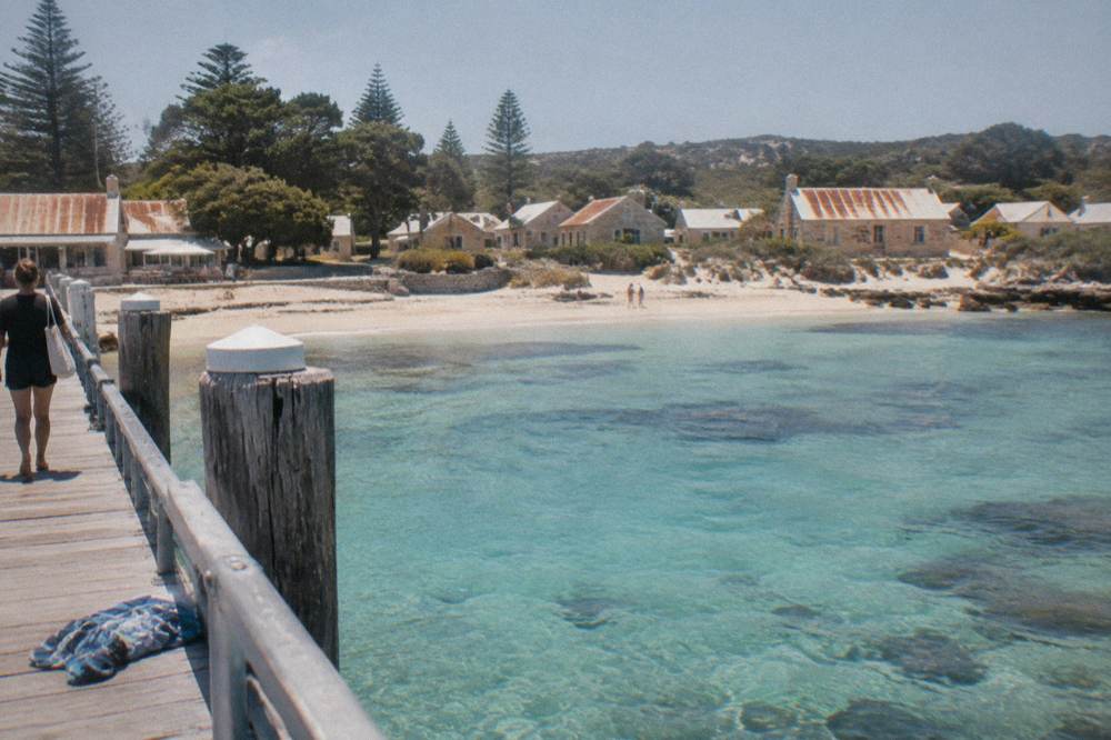 The ferry terminal at Thomson Bay with turquoise water and the settlement buildings behind