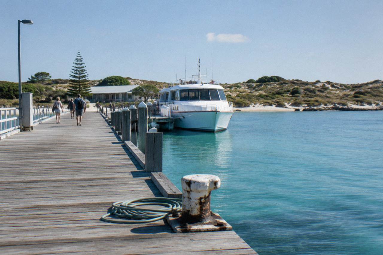 A ferry at the jetty in Thomson Bay on Rottnest Island with calm turquoise water