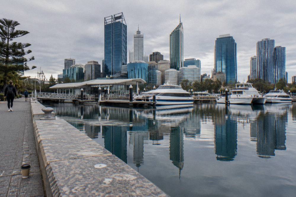 Elizabeth Quay in Perth with city buildings reflected in the waterfront and moored boats