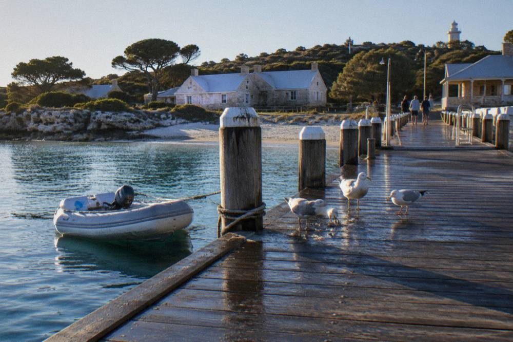 Wooden main jetty at Thomson Bay with the Rottnest settlement buildings behind it