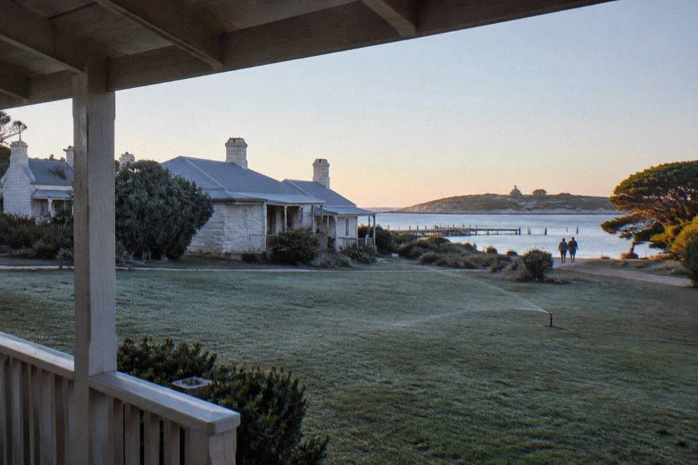 Soft early morning light over the lawns and heritage buildings of the Thomson Bay settlement