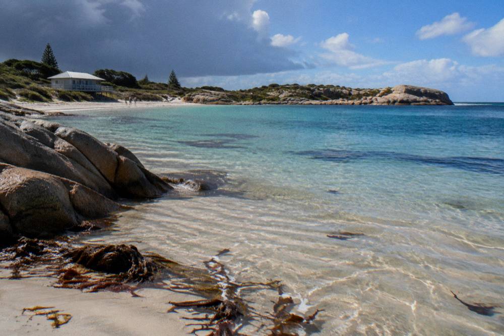 Calm sheltered bay at Rottnest Island with gentle waves on sand and no people
