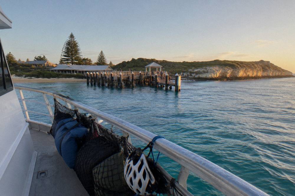 Bicycles secured in rows on the deck of a passenger ferry crossing open water