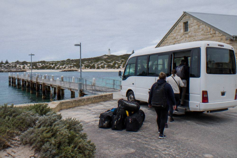 Passengers boarding a small tour bus near the Rottnest Island settlement jetty