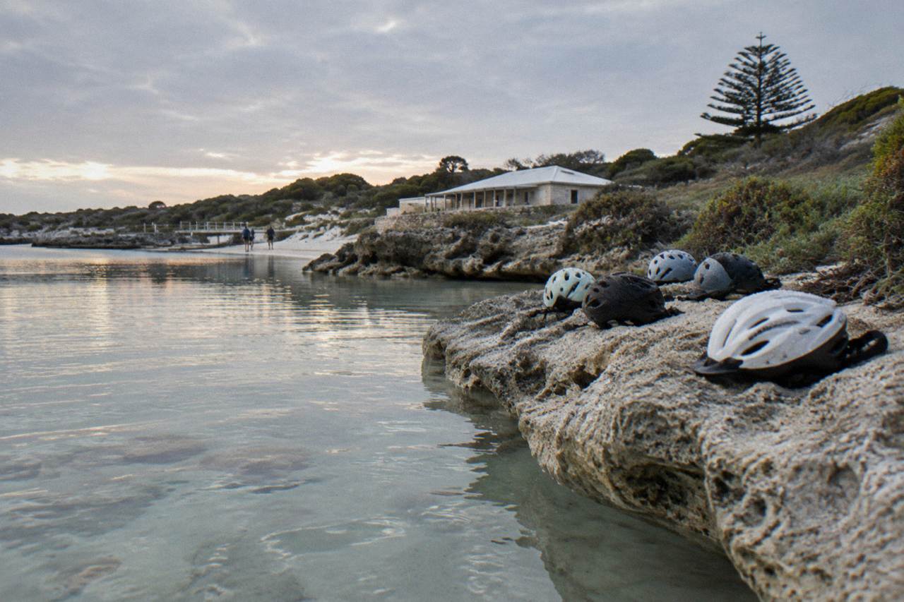 Bicycles parked near the sand at a sheltered Rottnest Island bay