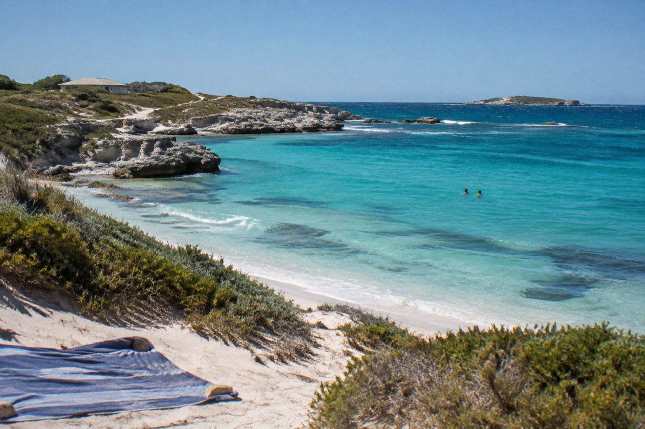 Clear summer sky over turquoise water and a sandy bay on Rottnest Island