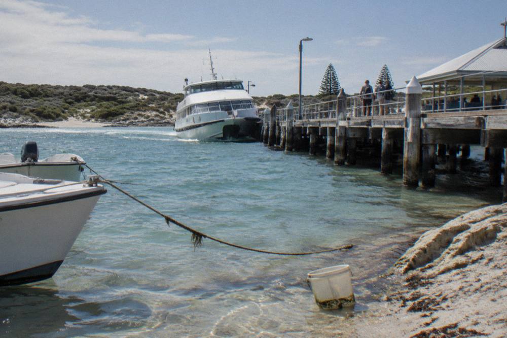 A passenger ferry approaching the Main Jetty at Thomson Bay with moored boats in the foreground