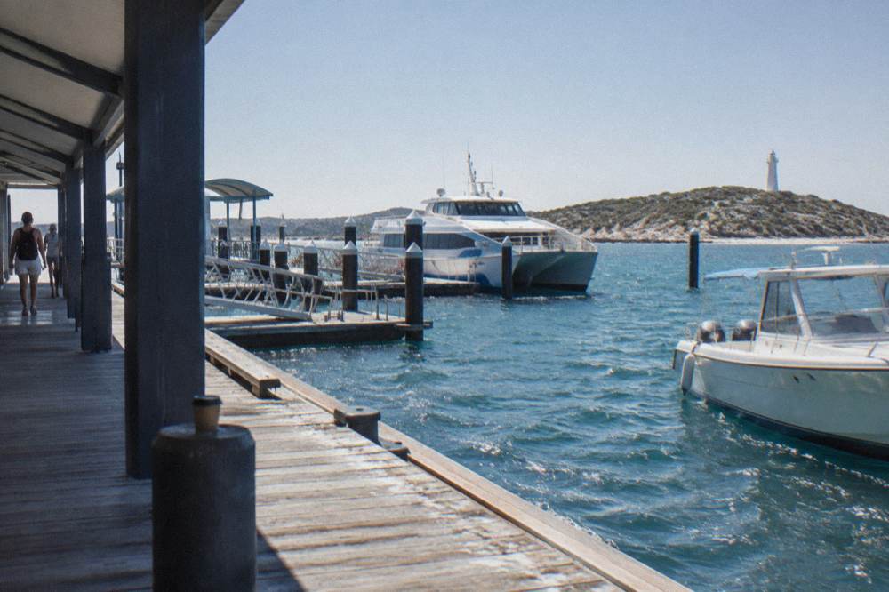Ferry terminal at Hillarys Boat Harbour with moored boats in morning light